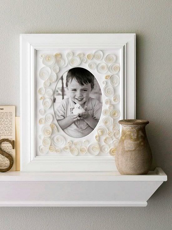white picture frame with quilled paper spirals decorating it