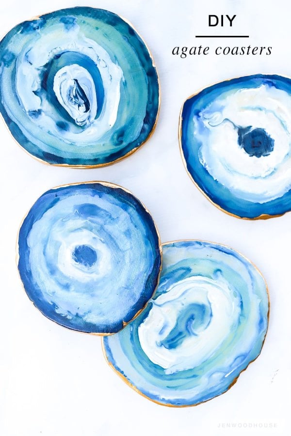 Faux Agate DIY coasters are painted in layered shades of blue with metallic gold edges.