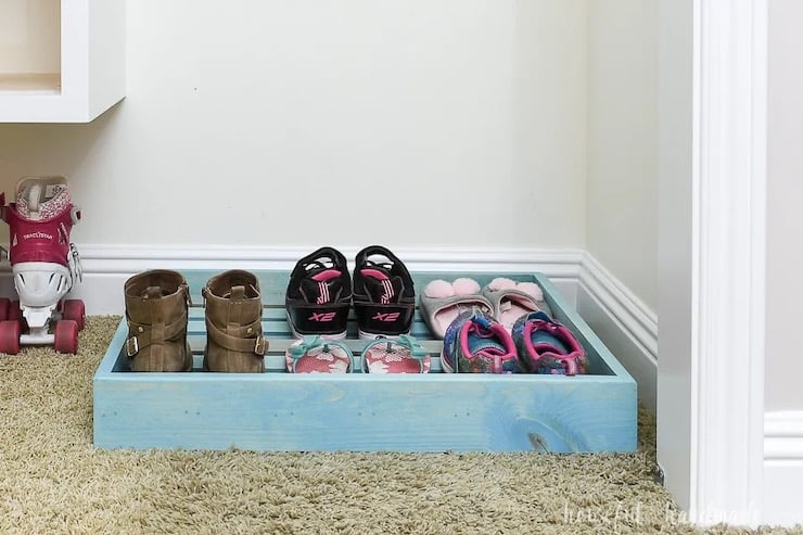 blue shoe storage rack tray on closet floor