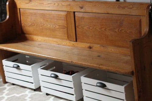 rolling shoe storage bins under a bench