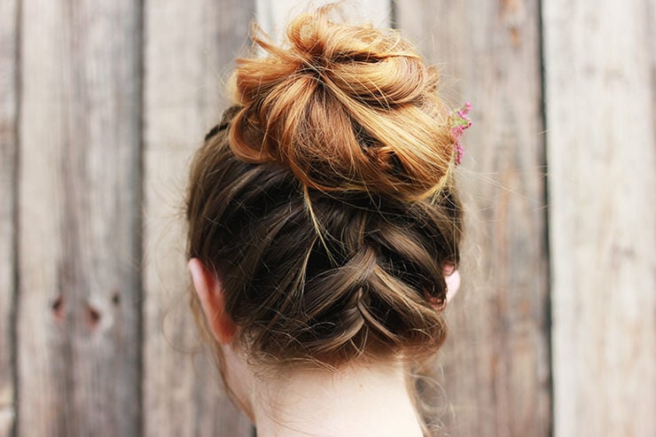 high messy bun with a French braid below