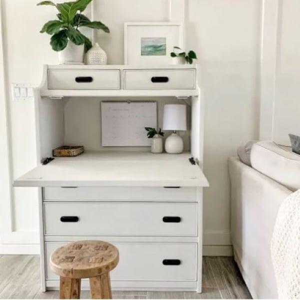 White dresser converted into a secretary-style desk with fold-down workspace and storage