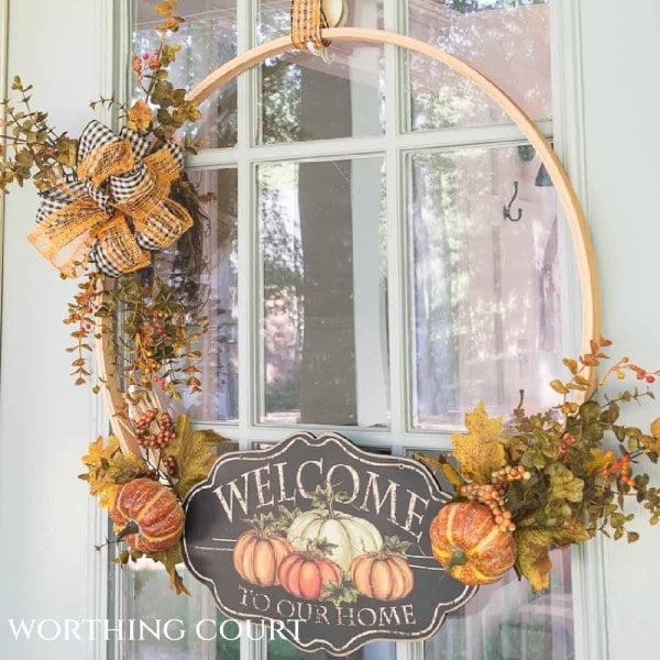 Embroidery hoop fall wreath with pumpkins, foliage, and a welcome sign