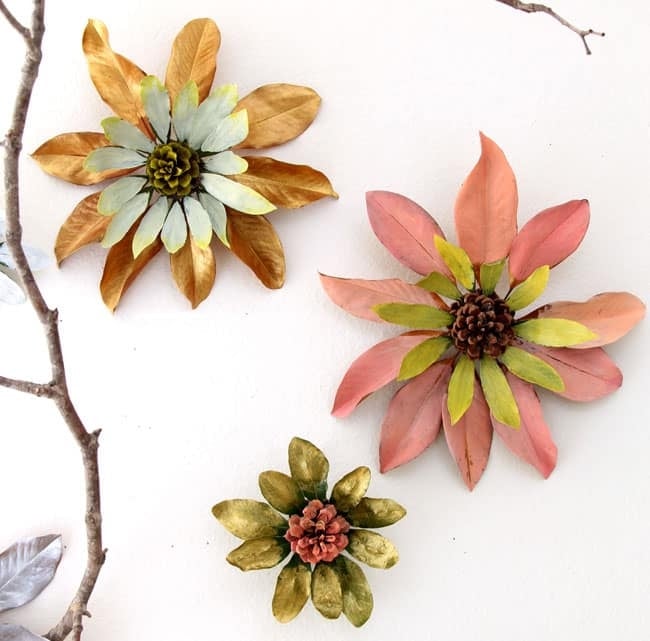 large flower shapes made with pinecones and painted, dried leaves