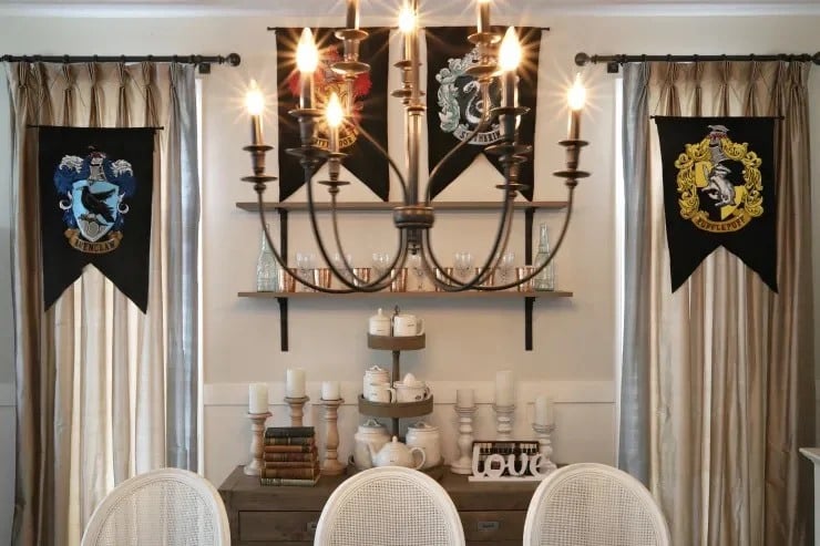 Harry Potter house banners and a gothic chandelier used as Halloween party decor