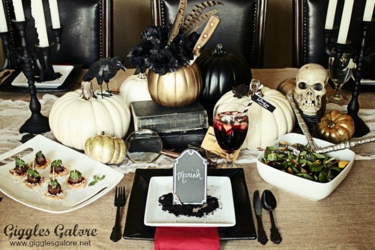 Spooky Halloween dinner table with pumpkins, skulls, candles, and gothic décor.