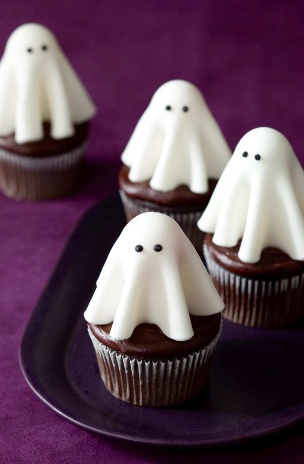 Chocolate cupcakes topped with fondant ghosts with tiny black eyes