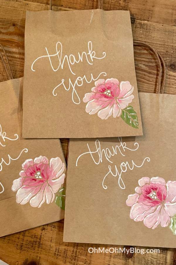 Brown paper gift bag with thank you and painted flower on it