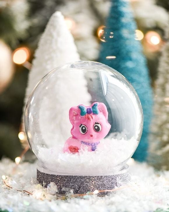 miniature snow globe holding a small children's toy inside