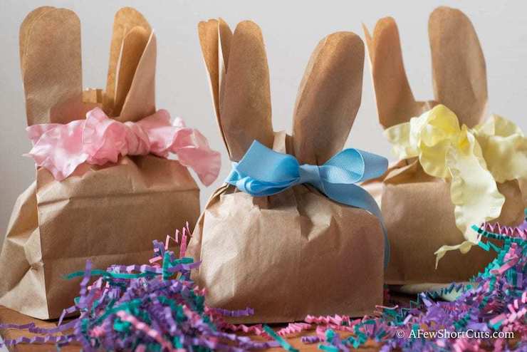 Cut a small paper gift bag with bunny ears at the top and tie with a bow