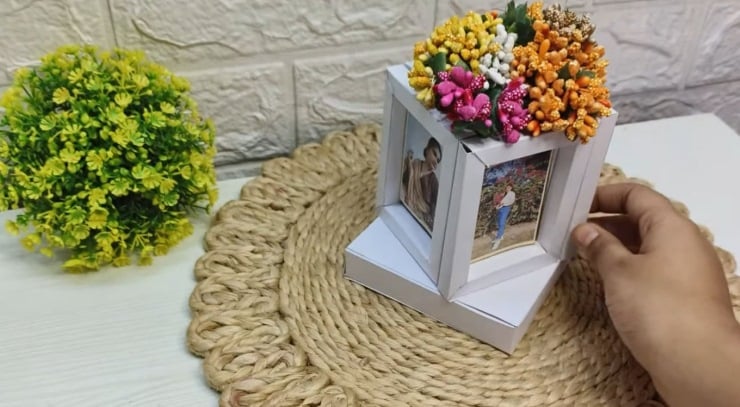 DIY rotating photo frame cube with pictures and flowers on top