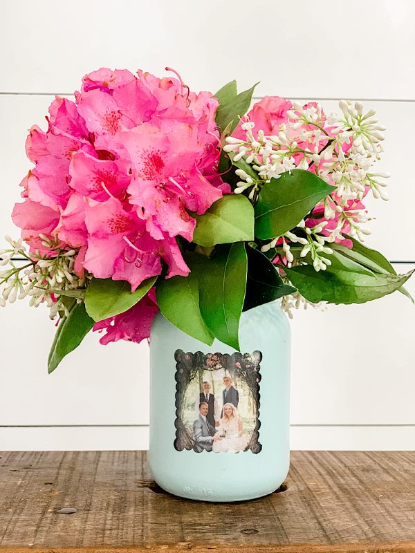 Mason jar vase with flowers and attached photo