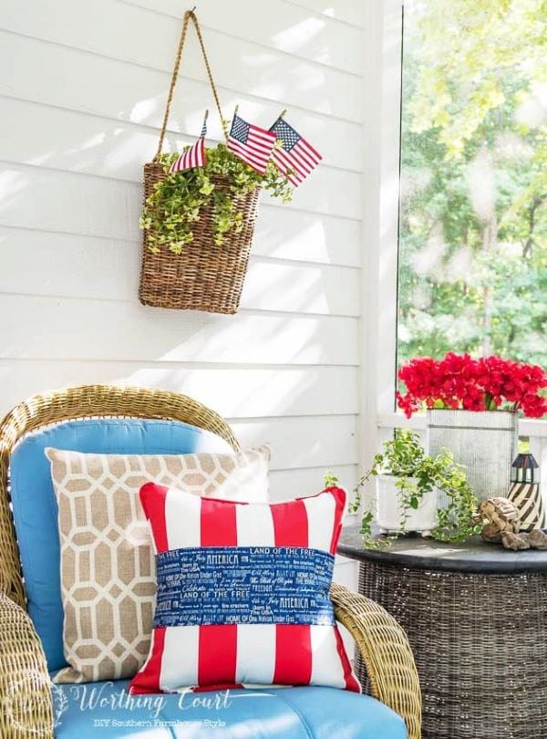 Red, white and blue pillow on chair on front porch