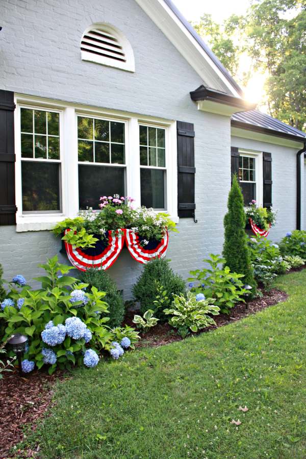 Red, white and blue bunting  below window flower box