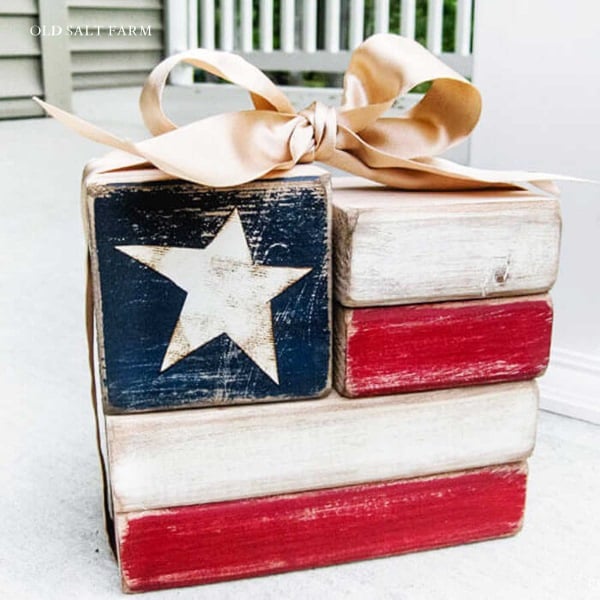 Red, white and blue wooden flag block on porch