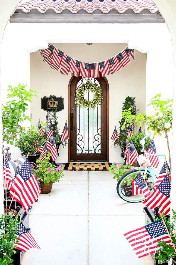 Pathway leading to front door with numerous dollar tree flags outlining it