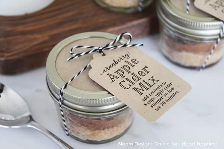 mini mason jar filled with apple cider mix with a gift tag tied around the top