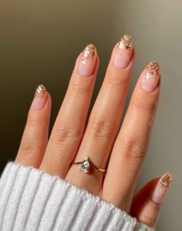 sheer pink nails with gold glittery tips