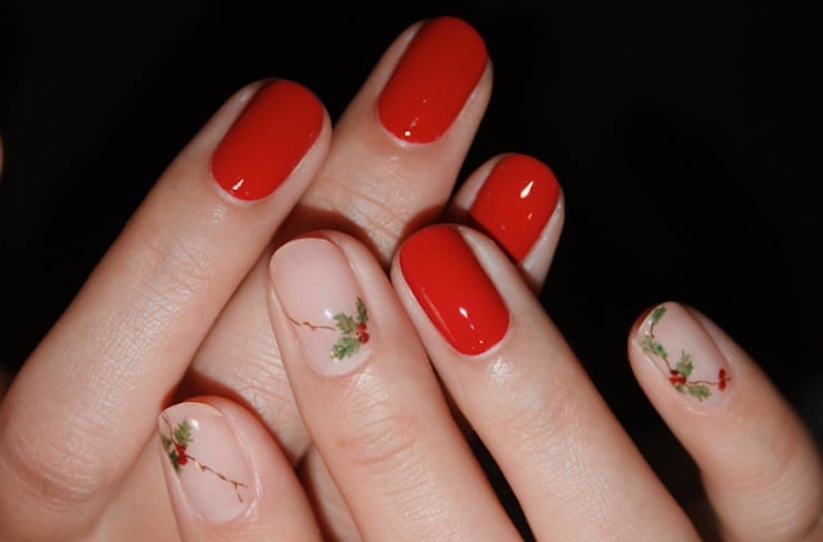 bright red nails with nude accent nails featuring holly branch designs