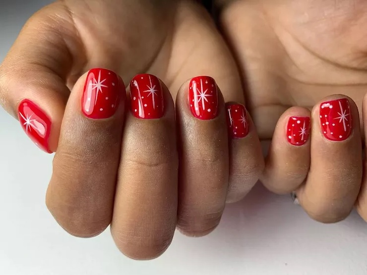 red bright red nails with red starburst sparkle designs on each