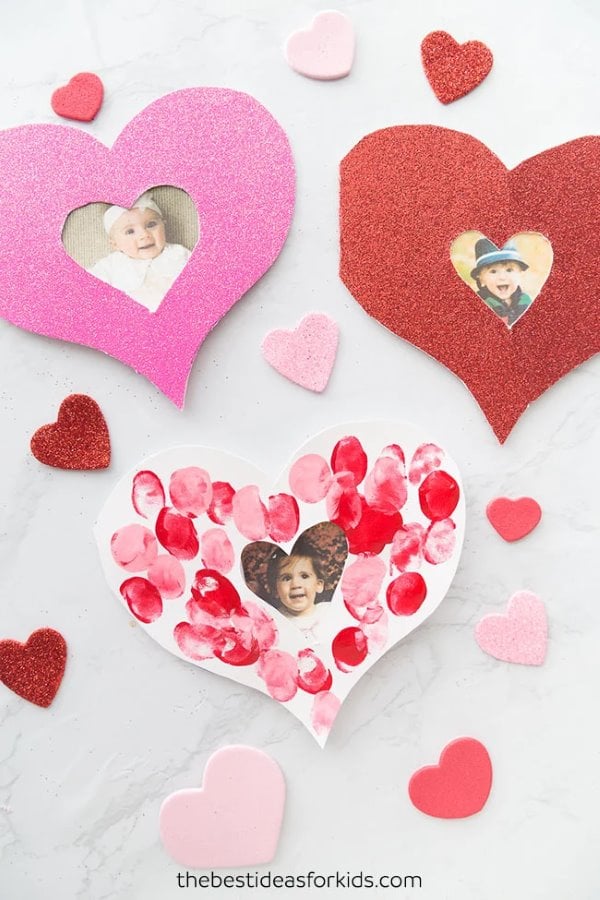 Heart-shaped Mother's Day card decorated with red fingerprint hearts and small photo cutouts