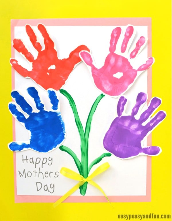 Colorful handprint flowers arranged as stems on Mother's Day card with bright background