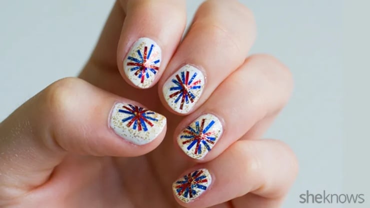 White nails with red, white, and blue glitter firework nail art on short rounded nails for Fourth of July manicure