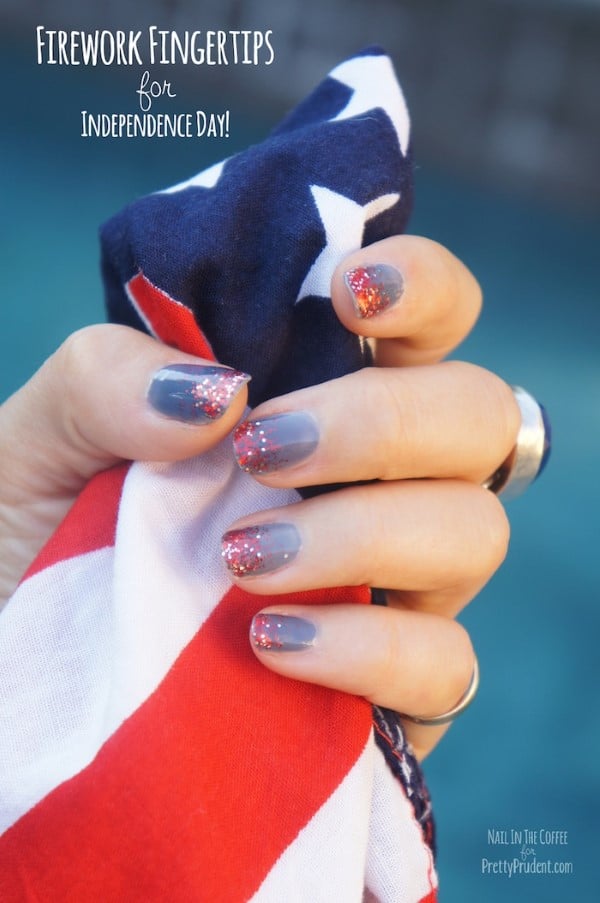 Gray nails with red glitter firework accents holding American flag fabric for Fourth of July nail art