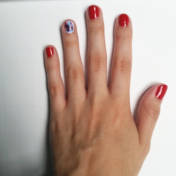 Red nails with patriotic firework accent nail in red, white, and blue design
