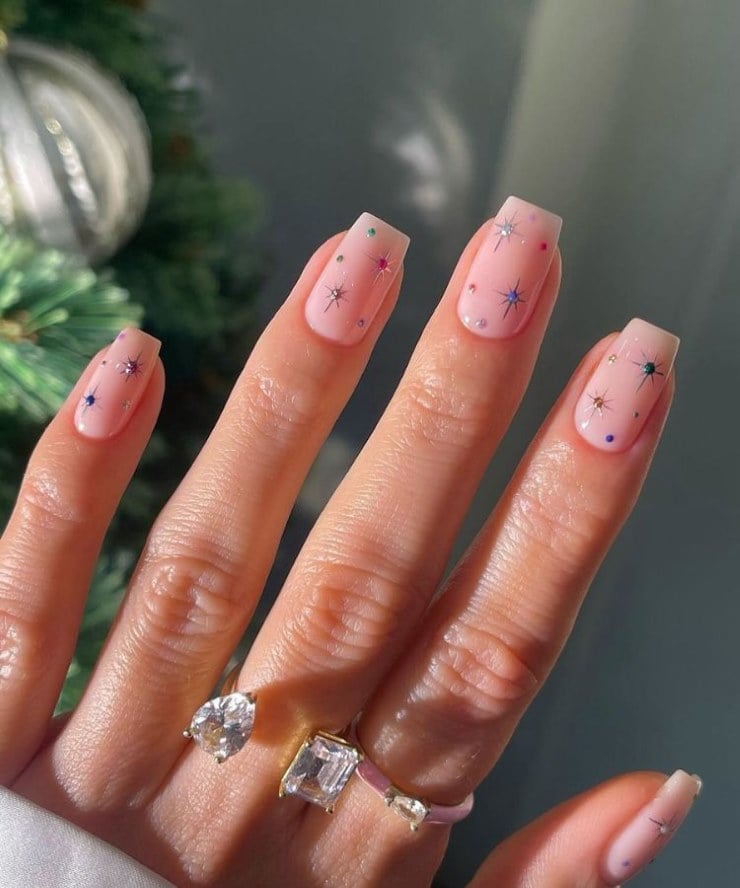 Simple pink firework nails with colorful sparkles and rhinestone accents on square nails