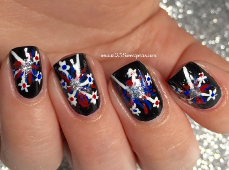 Black nails with red, white, and blue sparkler firework nail art and silver glitter centers